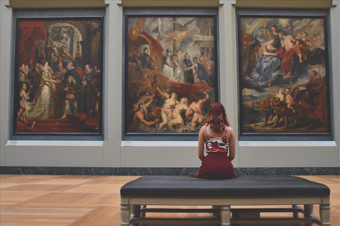 woman looking at paintings