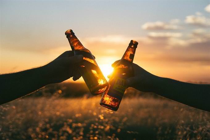 Brinde com cerveja no pôr do sol
