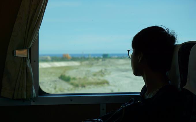 menino olhando pela janela do trem