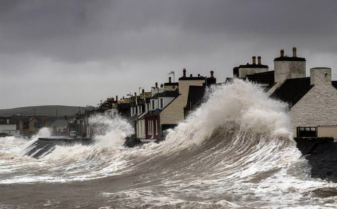 Sea waves crashing on homes
