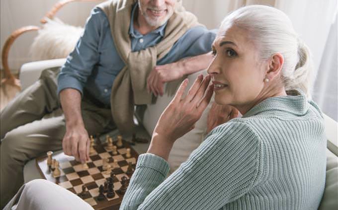 elderly couple playing chess