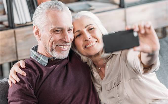 elderly couple taking a selfie
