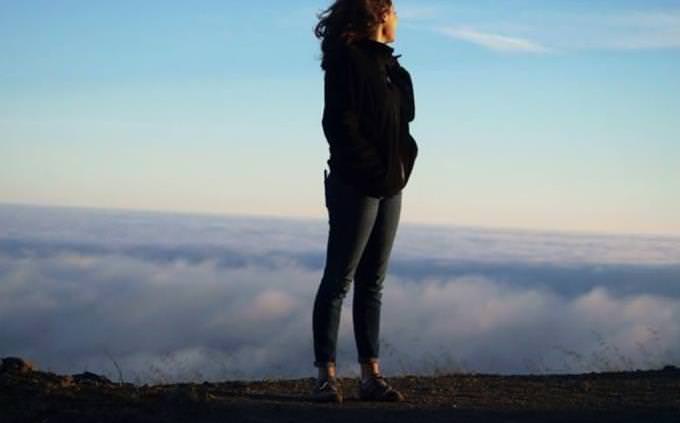 woman standing on mountain top