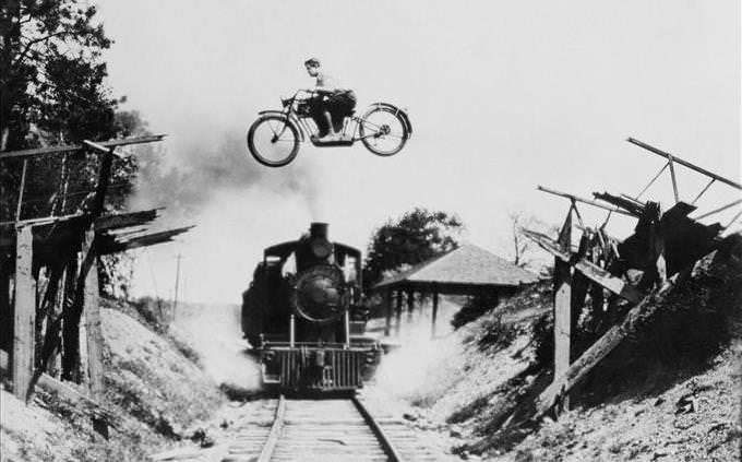 motorbike flying over train