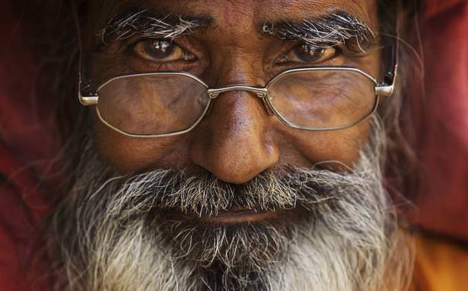 An older Indian man with glasses