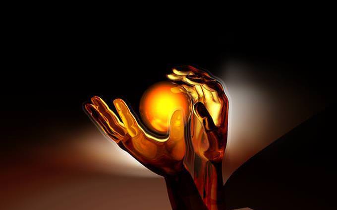 Picture of a ball of light floating between two hands