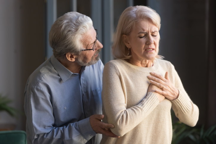 Ministroke (TIA) man worrying about a woman who has chest pain